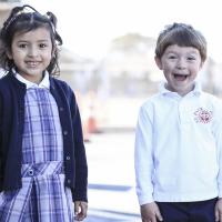 St. Paul School photo of children in front of mural