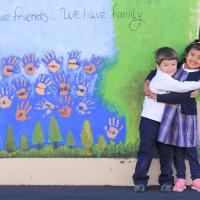 St. Paul School photo of children in front of mural