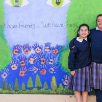 St. Paul School photo of children in front of mural